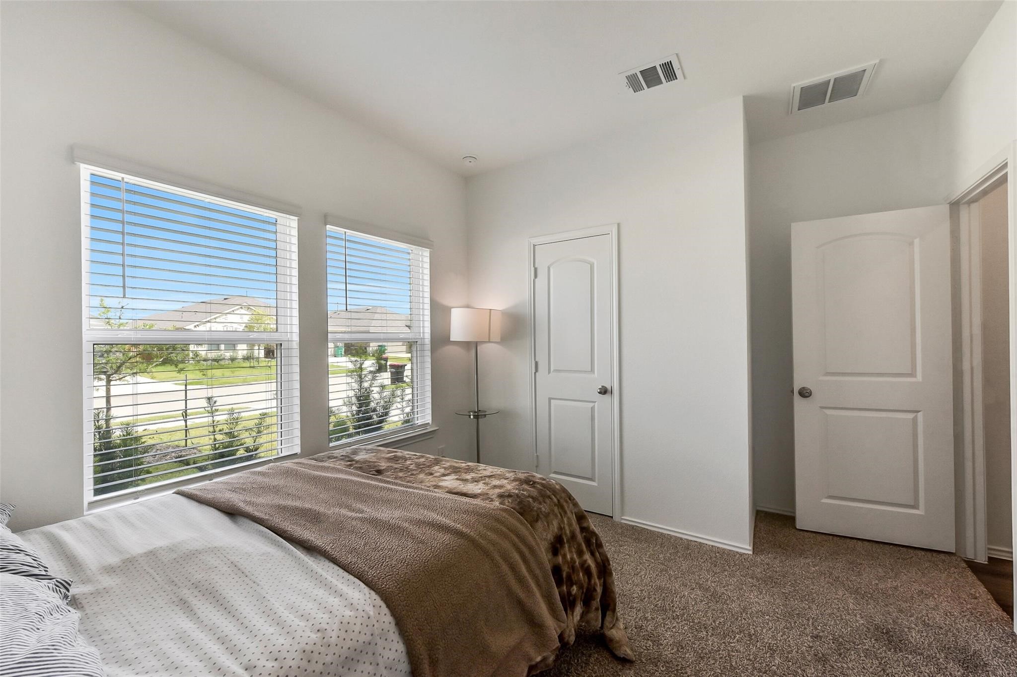4985 Blue Beetle Rdg Drive Katy, TX 77493 - Photo 22 of 40 a bedroom with a bed and a large window