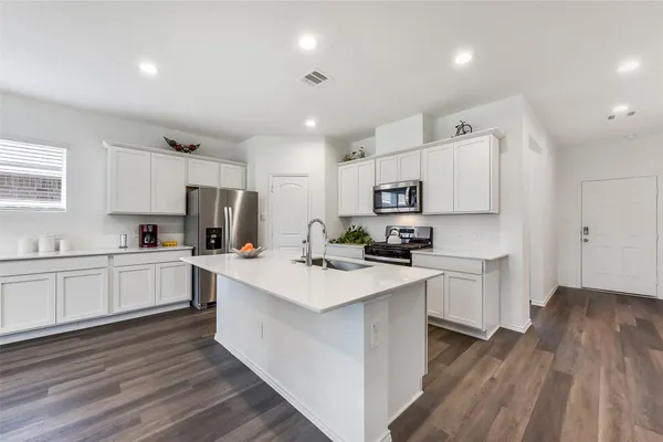 a kitchen with white cabinets and white appliances
