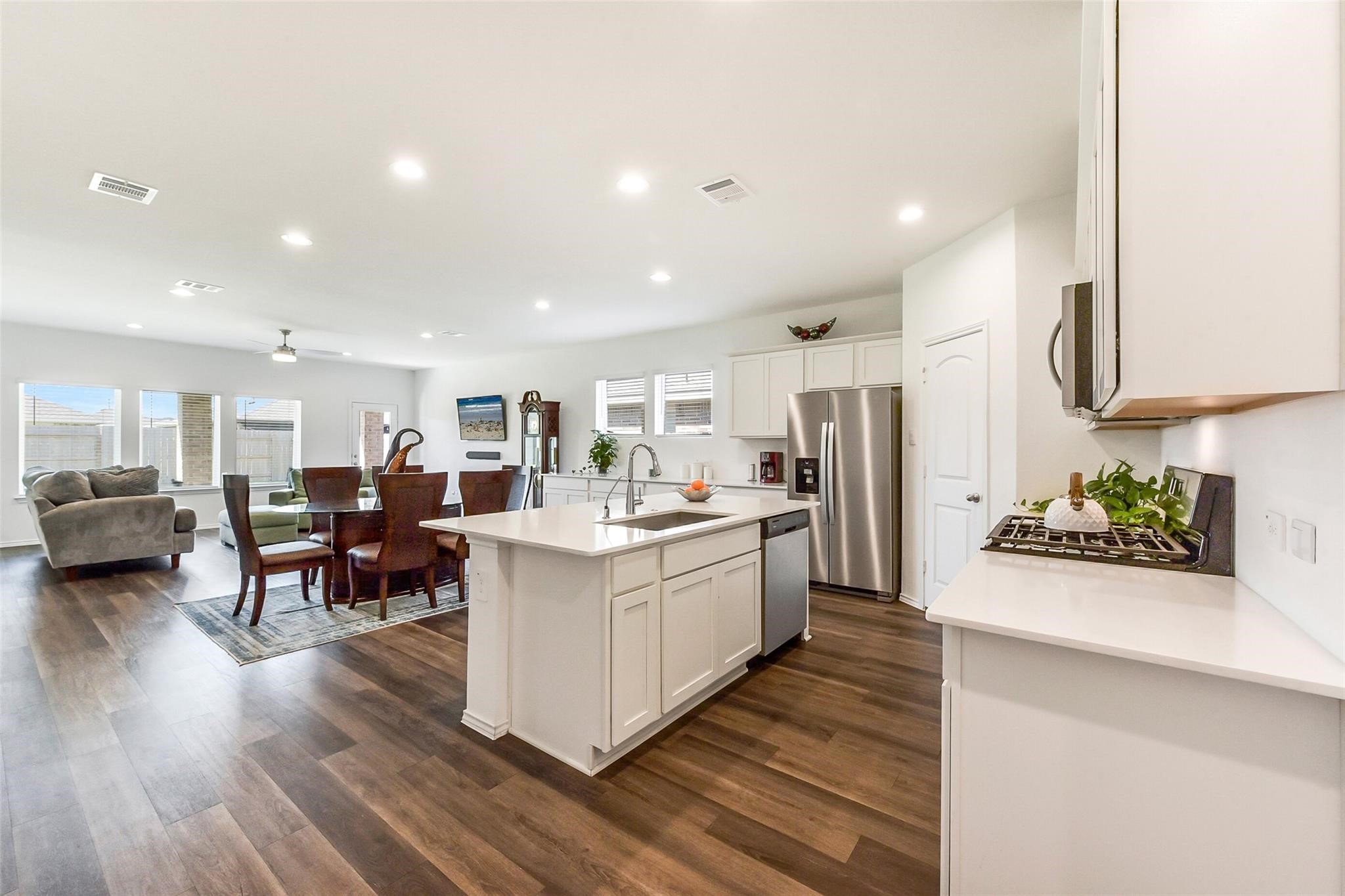 4985 Blue Beetle Rdg Drive Katy, TX 77493 - Photo 5 of 40 a large white kitchen with lots of counter top space and stainless steel appliances