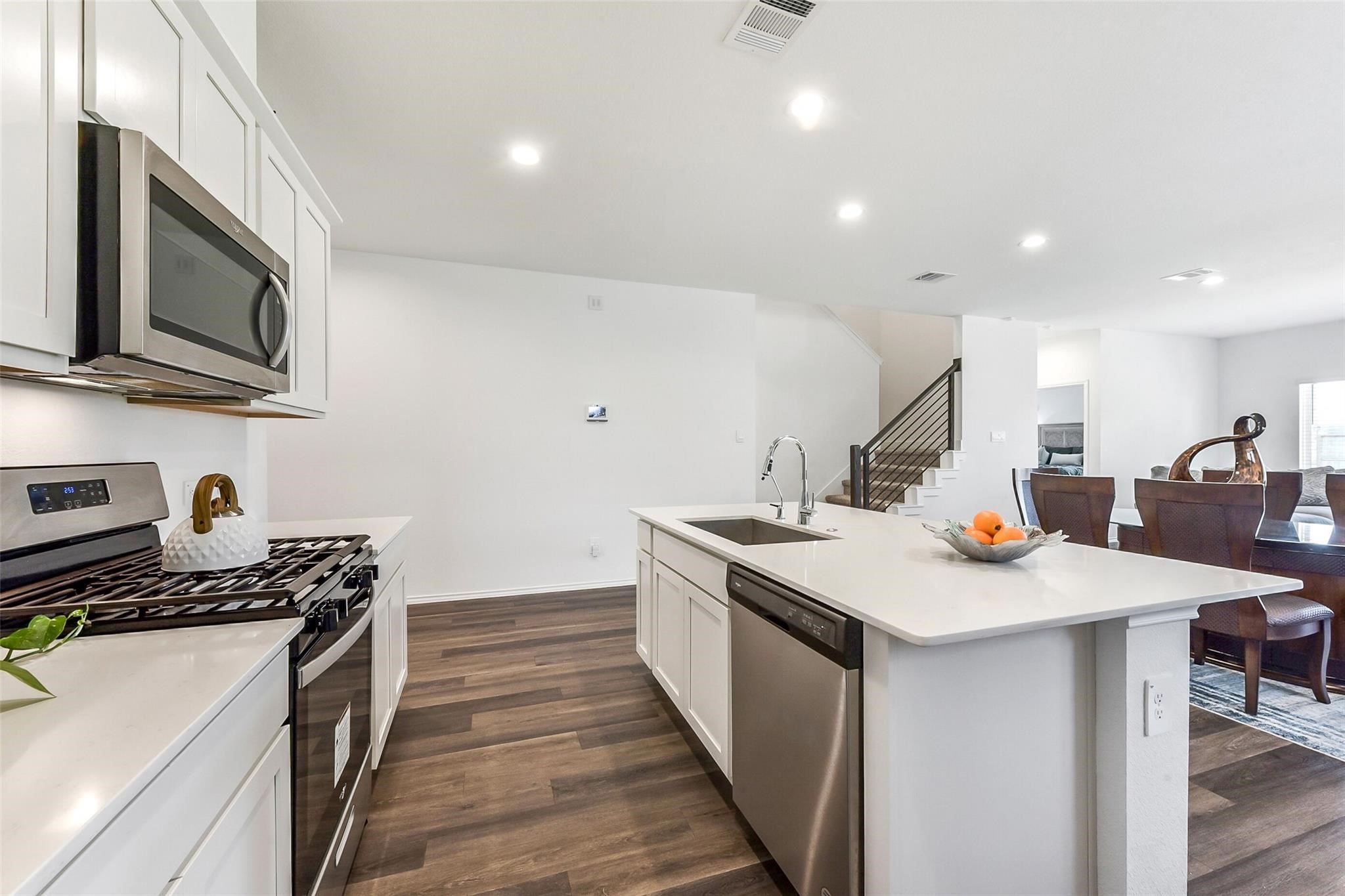4985 Blue Beetle Rdg Drive Katy, TX 77493 - Photo 8 of 40 a kitchen with stainless steel appliances a sink a stove top oven a counter space and cabinets
