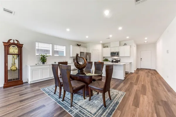 a view of a dining room with furniture and wooden floor