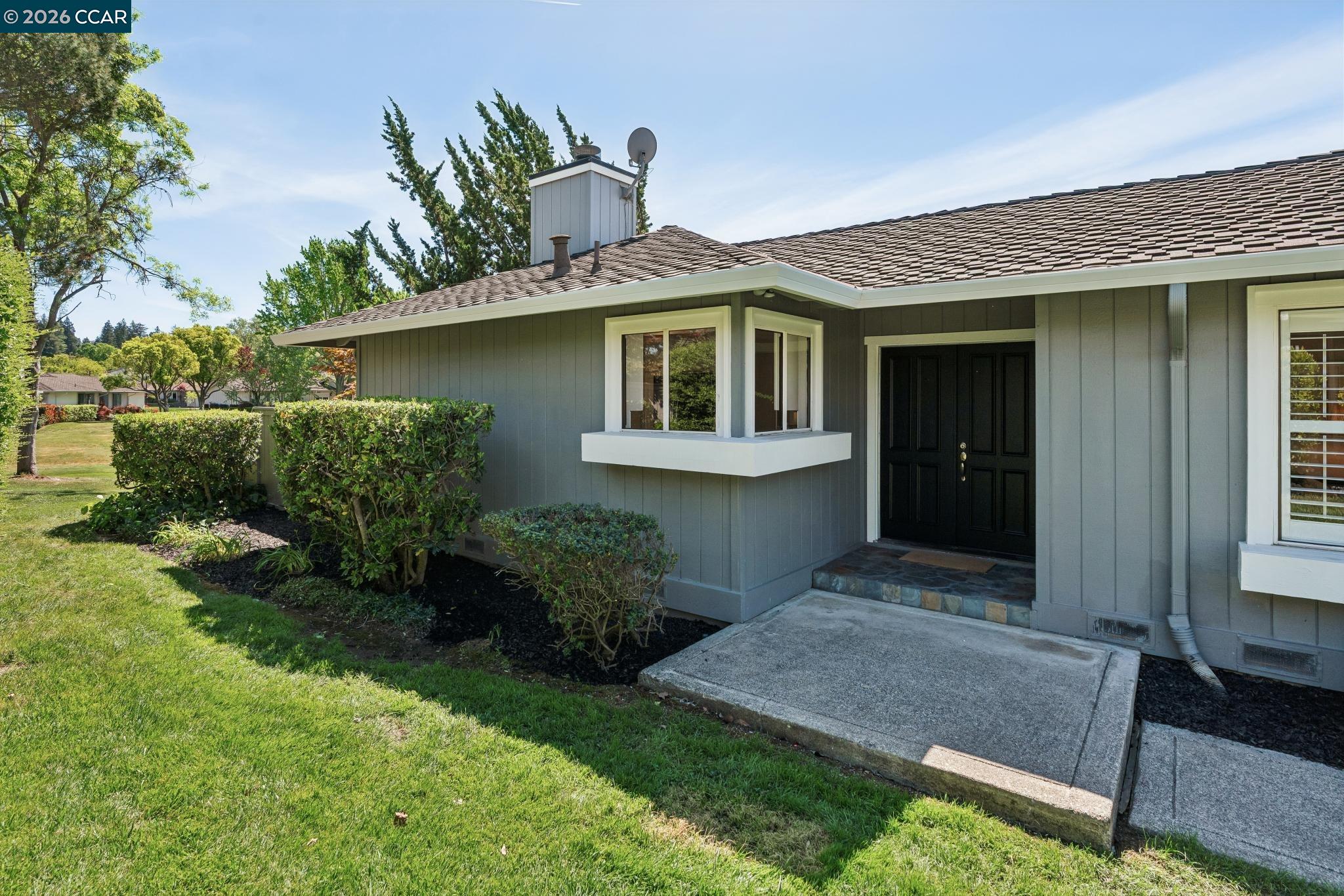 a front view of a house with a garden
