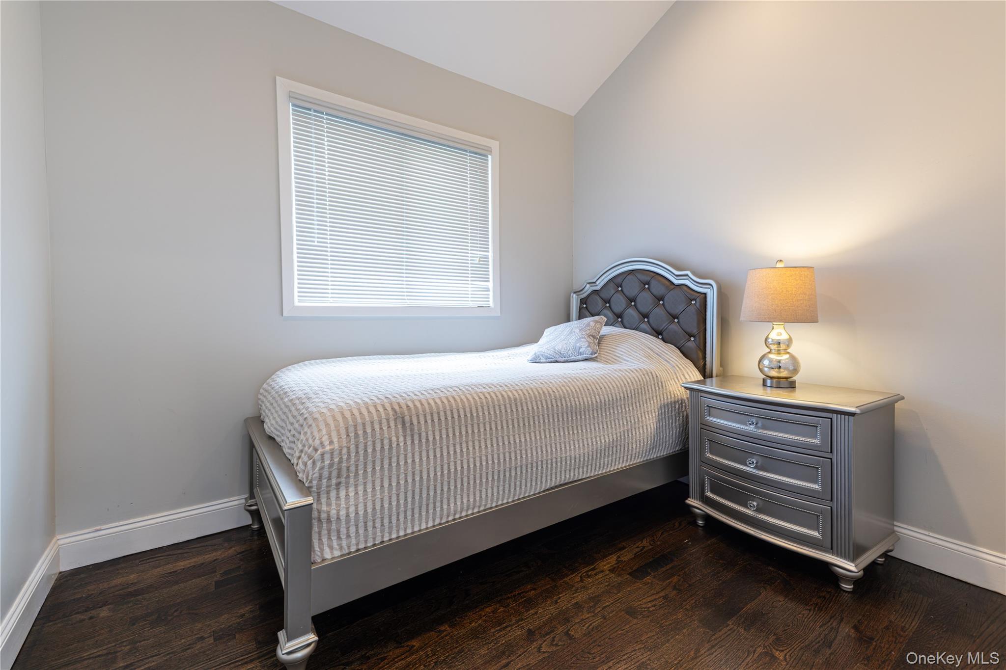 2590 Riverside Drive Wantagh, NY 11793 - Photo 15 of 27 Bedroom featuring dark wood-finish flooring.