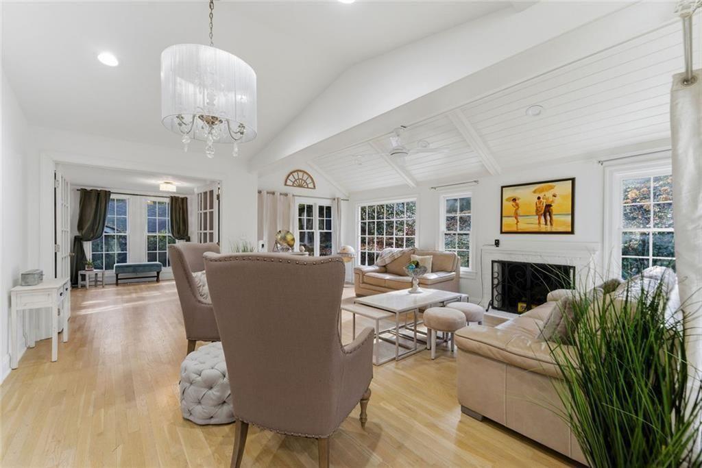 302 Hascall Road Northwest Atlanta, GA 30309 - Photo 16 of 56 a living room with furniture a dining table and a chandelier