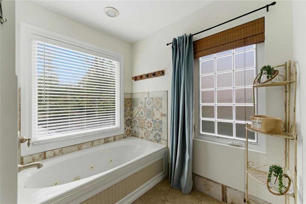 302 Hascall Road Northwest Atlanta, GA 30309 - Photo 27 of 56 a bathroom with a bathtub and a shower