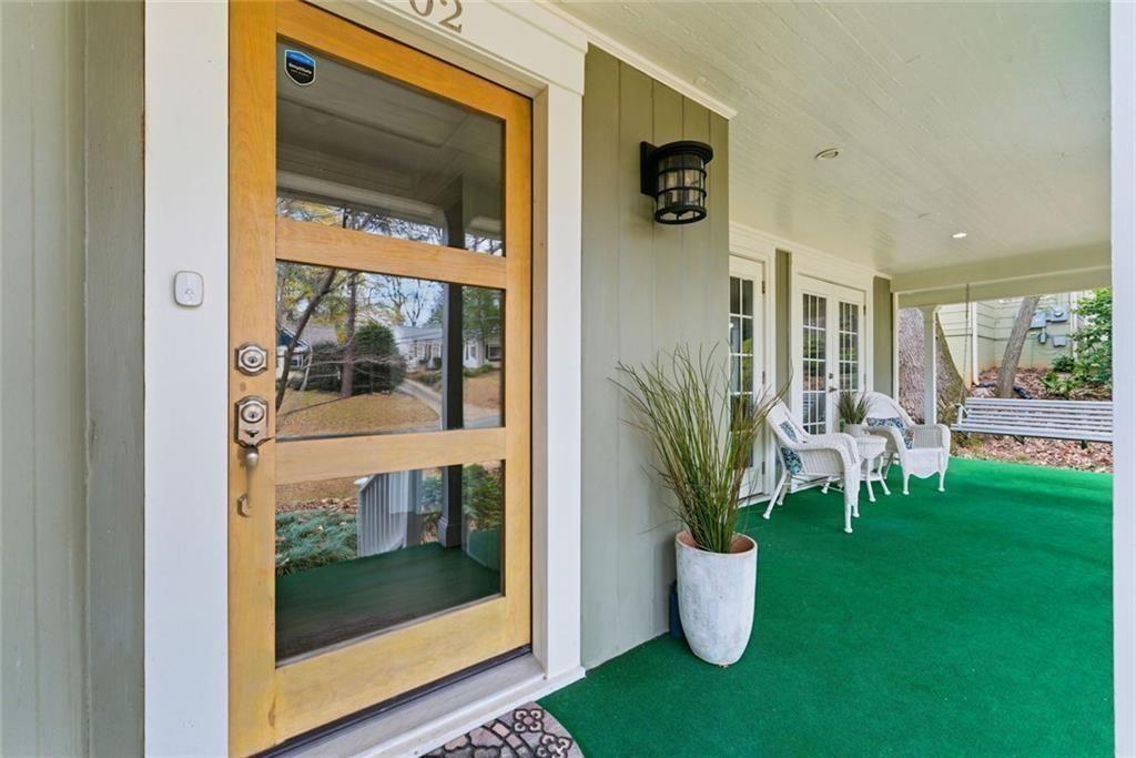 302 Hascall Road Northwest Atlanta, GA 30309 - Photo 3 of 56 a view of a porch with dining table and chairs