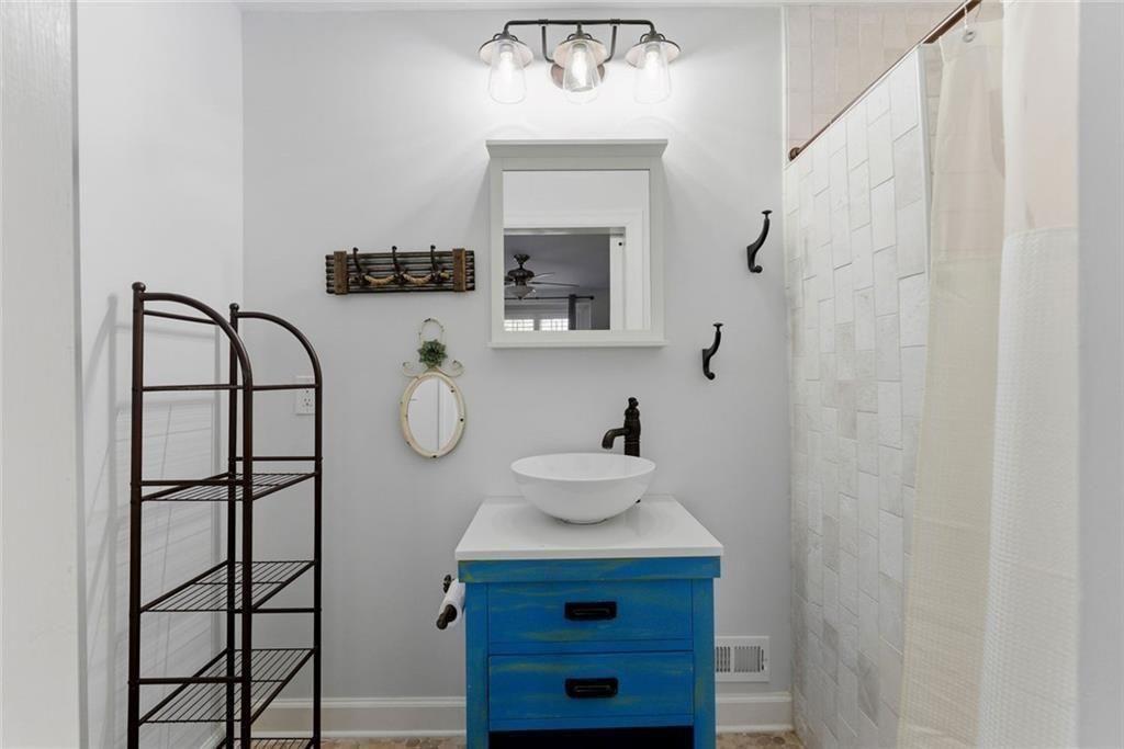 302 Hascall Road Northwest Atlanta, GA 30309 - Photo 32 of 56 a bathroom with a sink mirror and vanity
