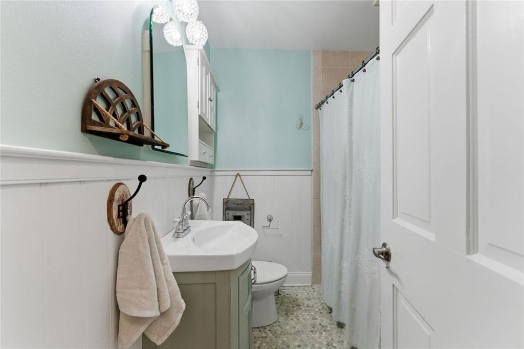 302 Hascall Road Northwest Atlanta, GA 30309 - Photo 34 of 56 a bathroom with a sink a toilet and mirror