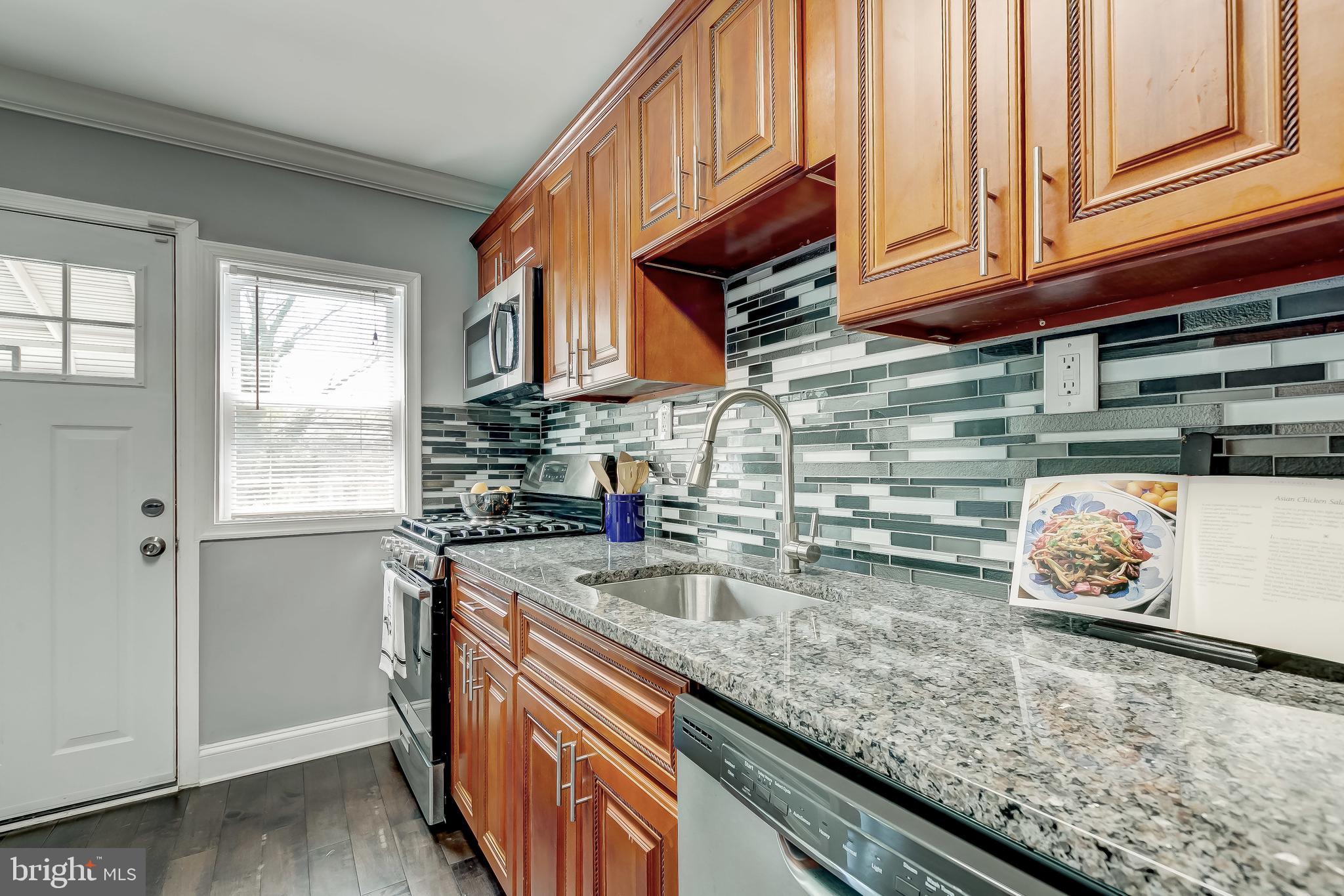 1419 Kingsway Road Baltimore, MD 21218 - Photo 13 of 38 a kitchen with granite countertop a sink and a stove