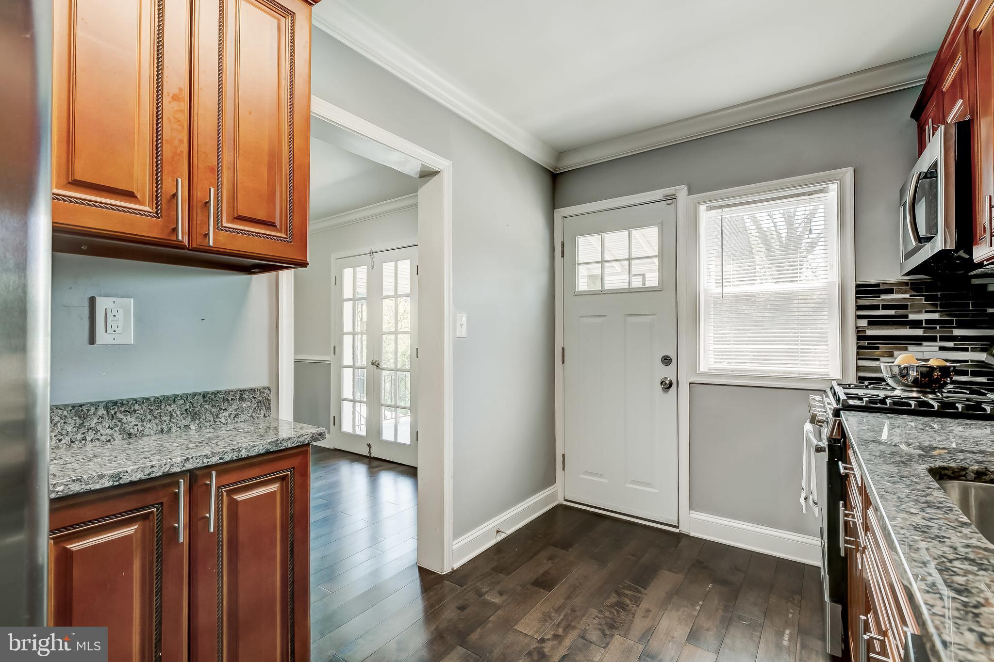 1419 Kingsway Road Baltimore, MD 21218 - Photo 14 of 38 a kitchen with granite countertop wooden cabinets and a stove