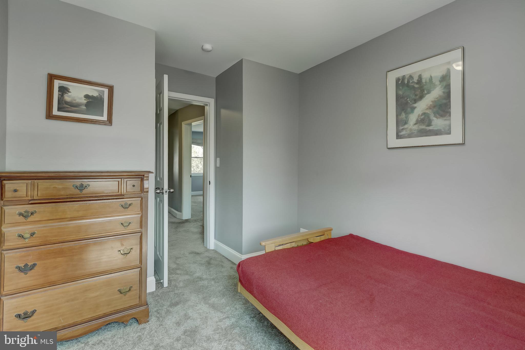 1419 Kingsway Road Baltimore, MD 21218 - Photo 17 of 38 a bedroom with a bed and lamp