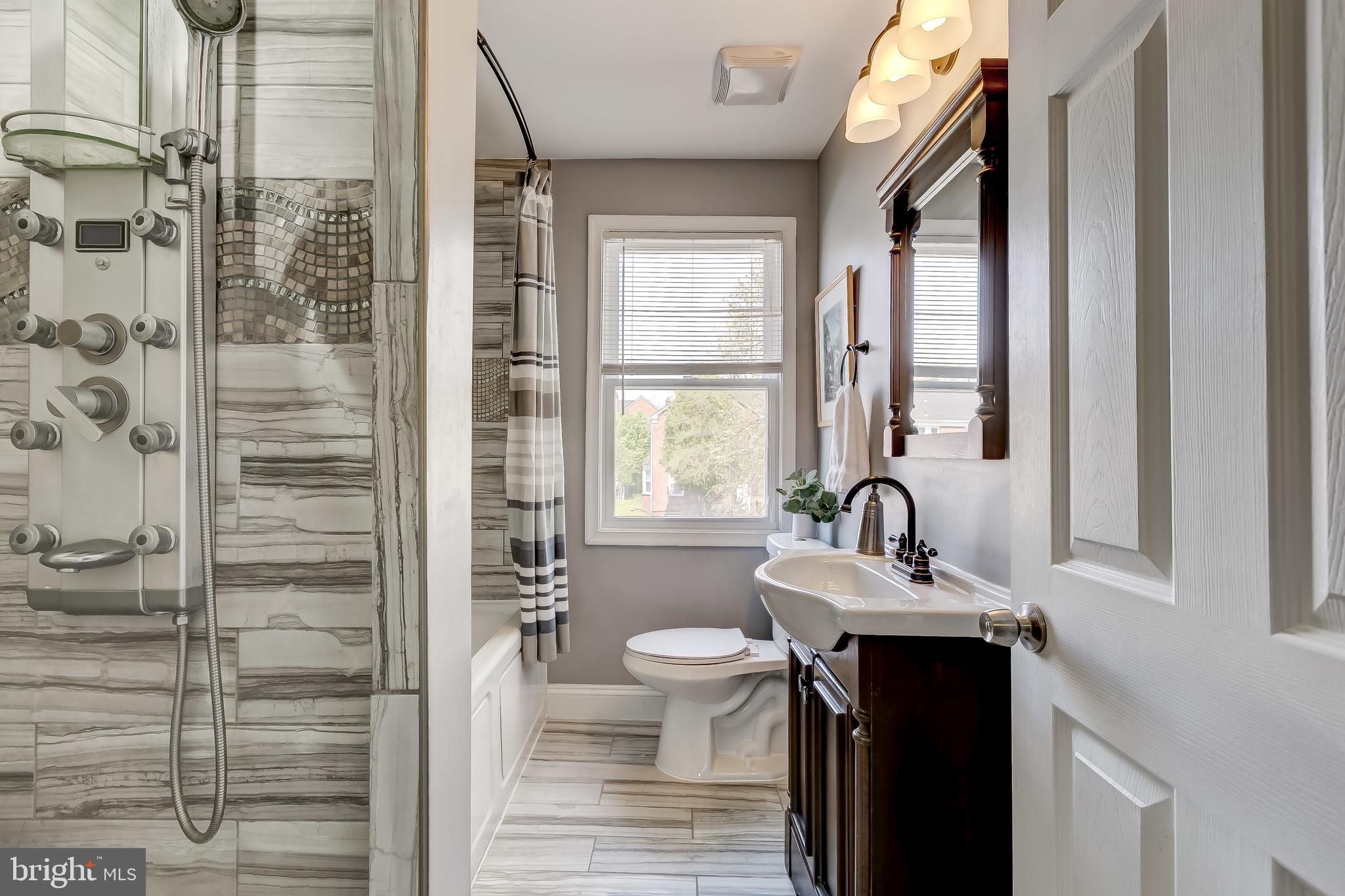 1419 Kingsway Road Baltimore, MD 21218 - Photo 20 of 38 a bathroom with a sink a toilet and shower