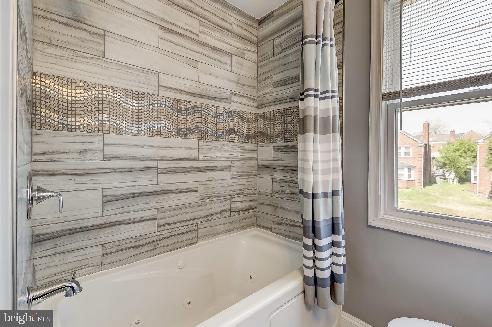 1419 Kingsway Road Baltimore, MD 21218 - Photo 22 of 38 a bathroom with a bathtub and a shower