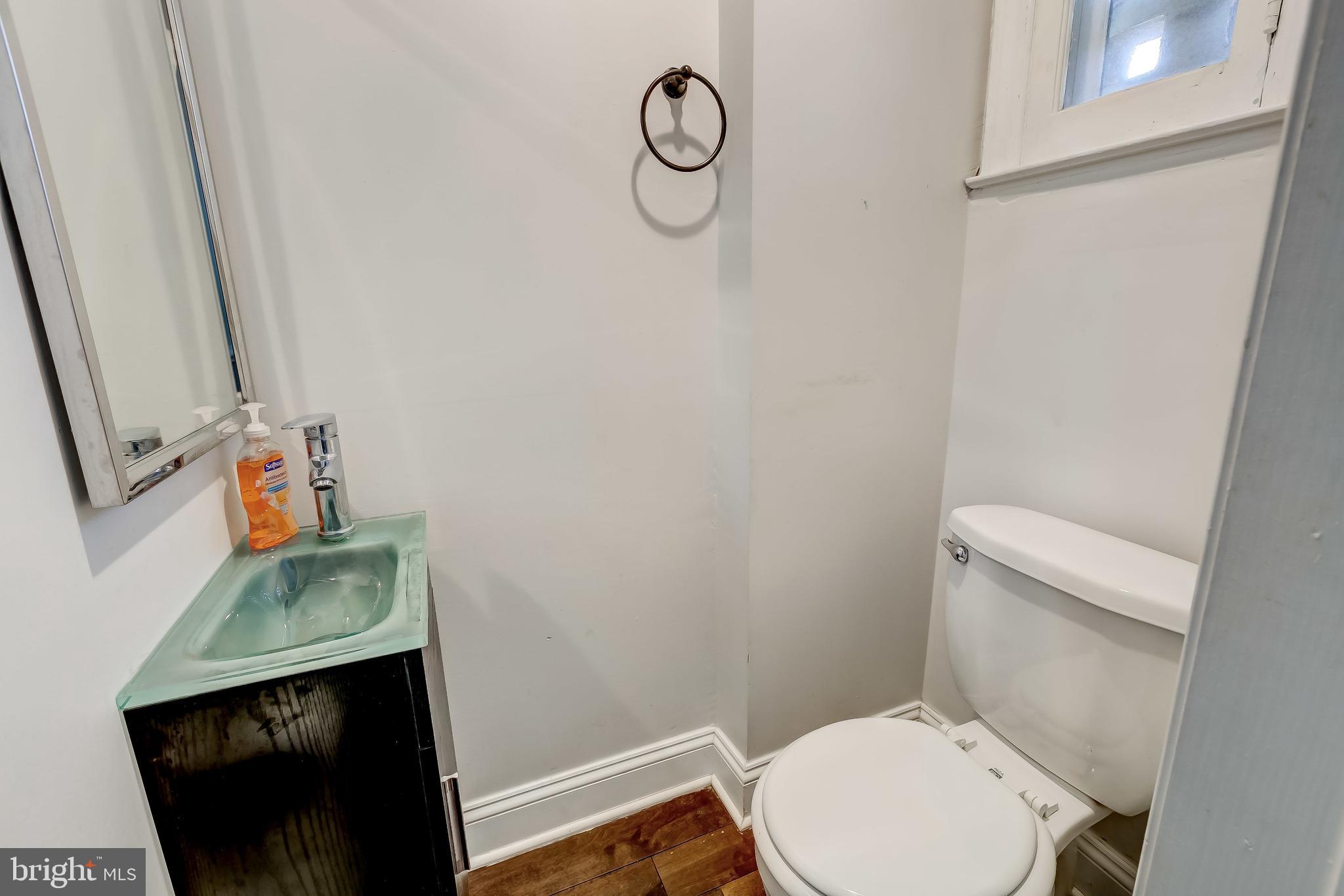 1419 Kingsway Road Baltimore, MD 21218 - Photo 34 of 38 a bathroom with a toilet and a sink
