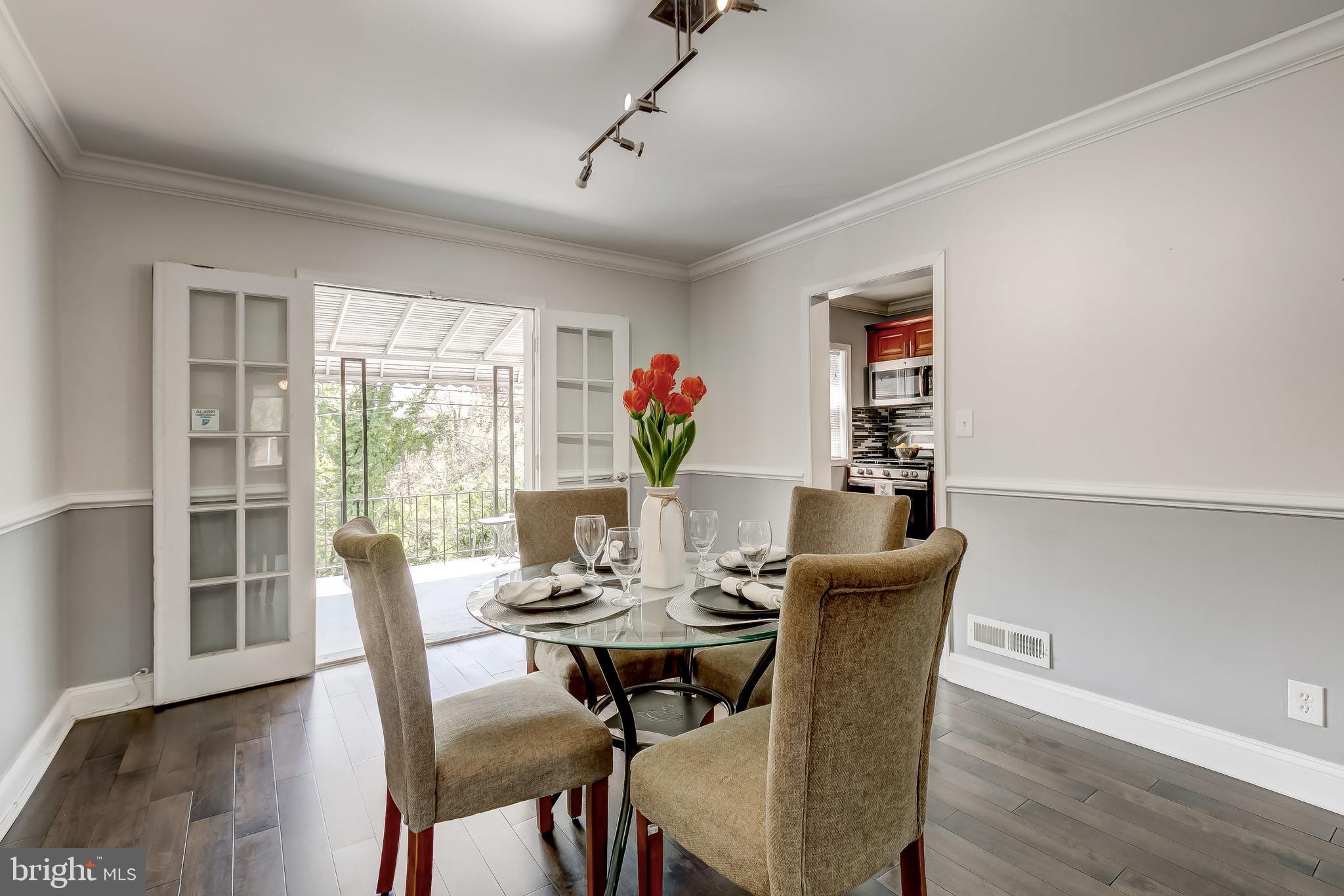1419 Kingsway Road Baltimore, MD 21218 - Photo 9 of 38 a view of a dining room with furniture window and wooden floor