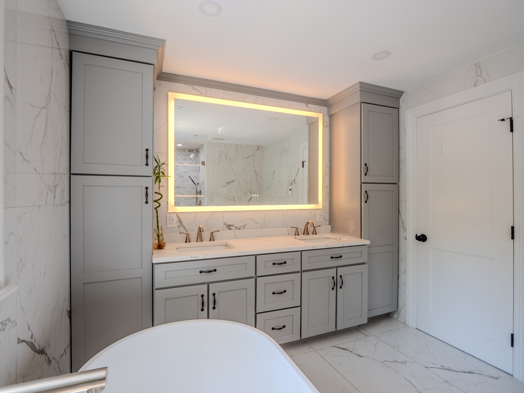 159 Mishawum Road Woburn, MA 01801 - Photo 17 of 41 a bathroom with a double vanity sink toilet mirror and window