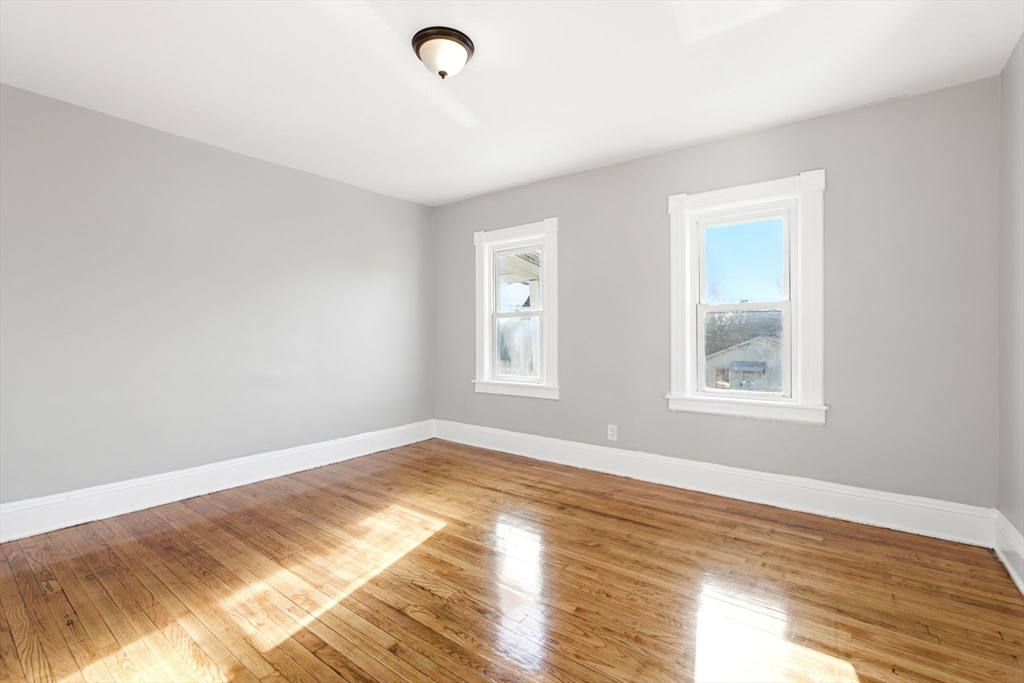 58 Governor Street Springfield, MA 01104 - Photo 11 of 23 a view of an empty room with wooden floor and a window