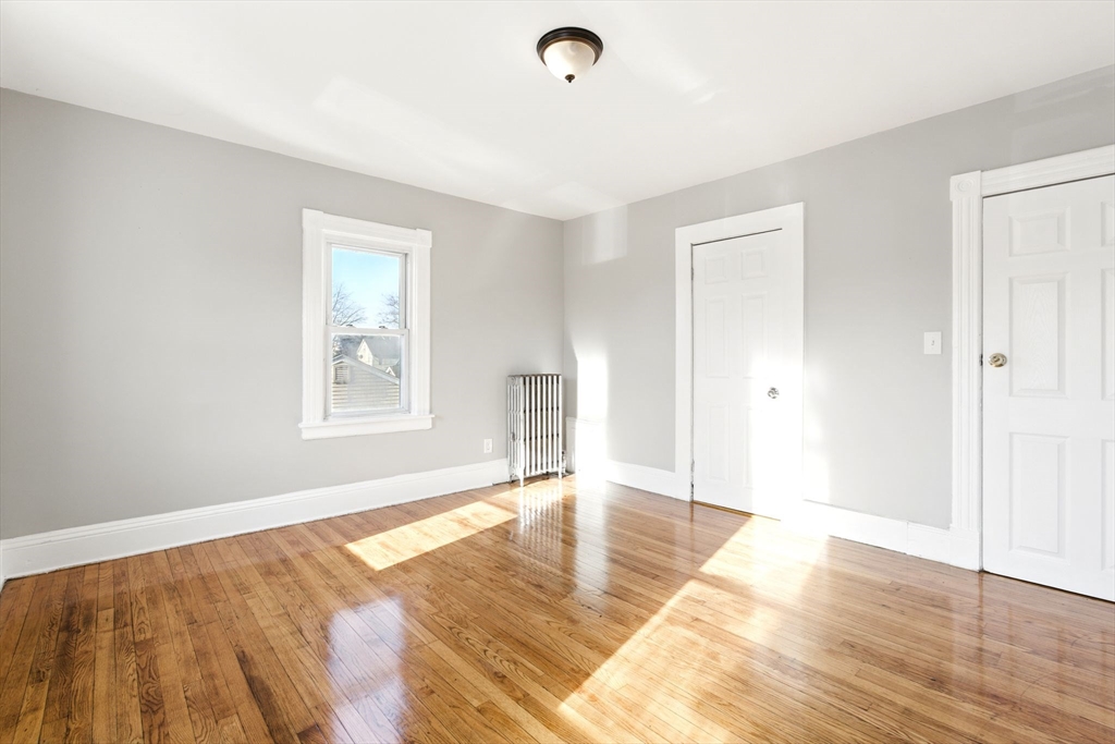 58 Governor Street Springfield, MA 01104 - Photo 12 of 23 a view of empty room with wooden floor and fan
