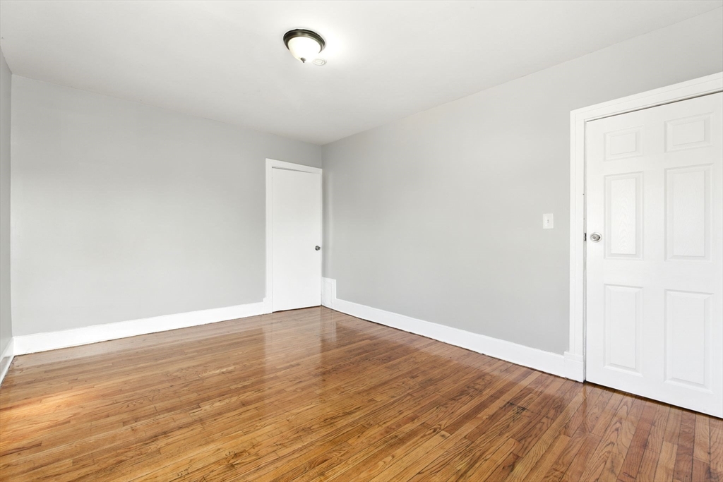 58 Governor Street Springfield, MA 01104 - Photo 15 of 23 a view of an empty room with wooden floor