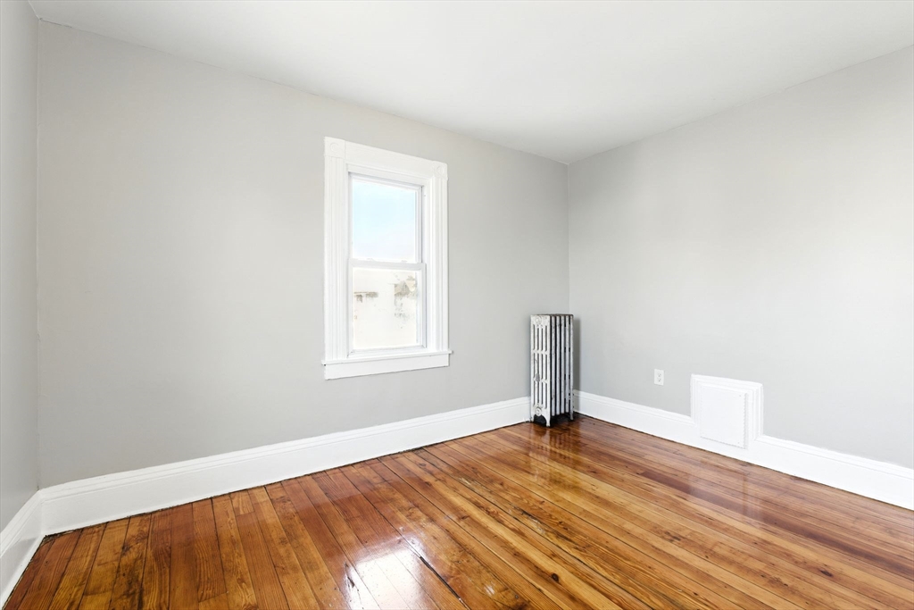 58 Governor Street Springfield, MA 01104 - Photo 19 of 23 a view of empty room with wooden floor and fan