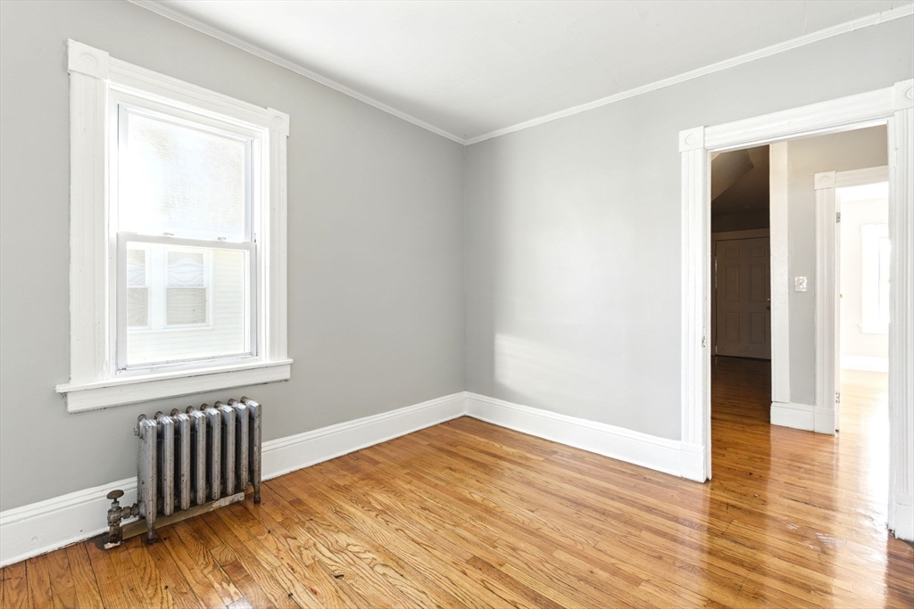58 Governor Street Springfield, MA 01104 - Photo 21 of 23 an empty room with wooden floor and windows
