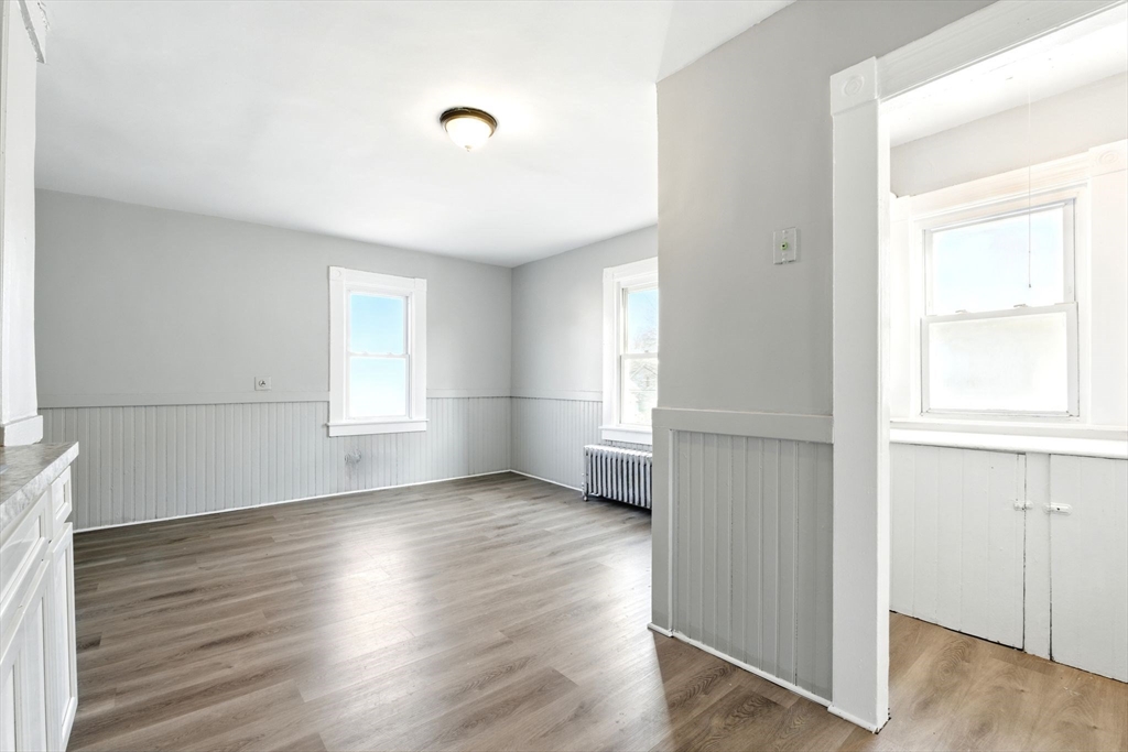 58 Governor Street Springfield, MA 01104 - Photo 6 of 23 an empty room with wooden floor and windows