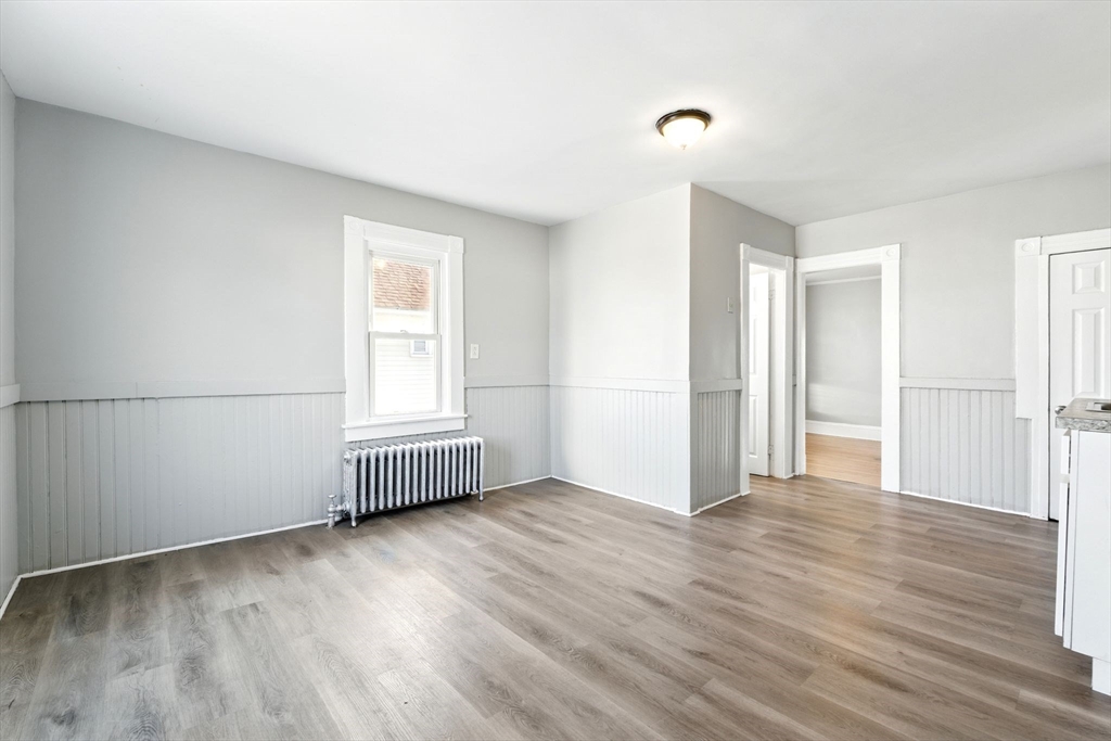58 Governor Street Springfield, MA 01104 - Photo 7 of 23 an empty room with wooden floor and windows