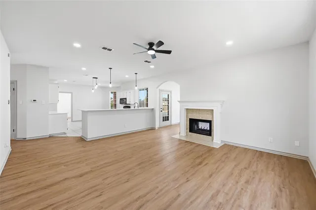 a view of a room with an empty space and a fireplace