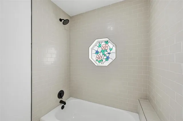 a white tub sitting next to a white sink and a white shower