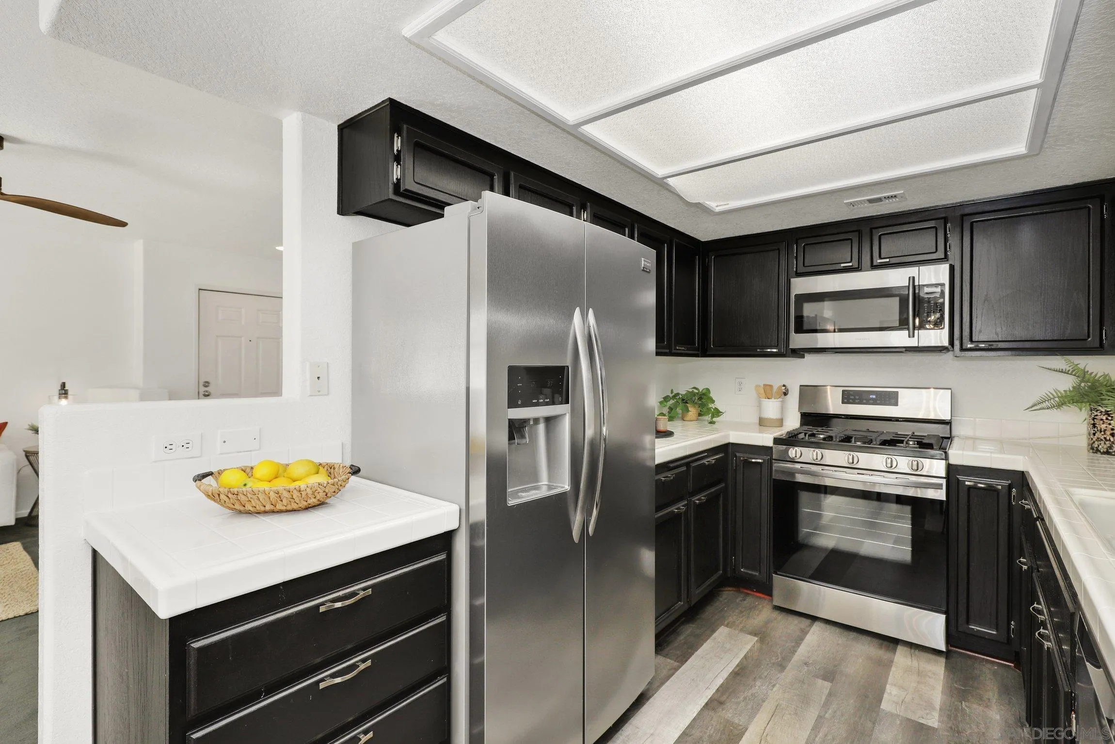 13957 Midland Road Poway, CA 92064 - Photo 8 of 26 a kitchen with stainless steel appliances a stove a sink and a refrigerator