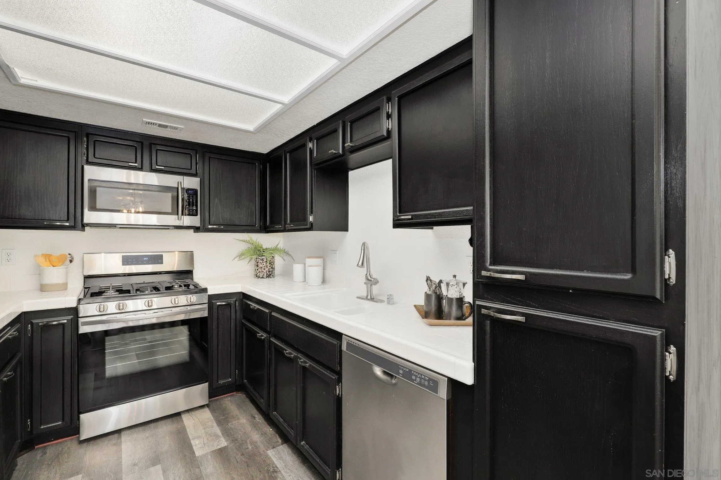 13957 Midland Road Poway, CA 92064 - Photo 9 of 26 a kitchen with stainless steel appliances a sink stove and microwave