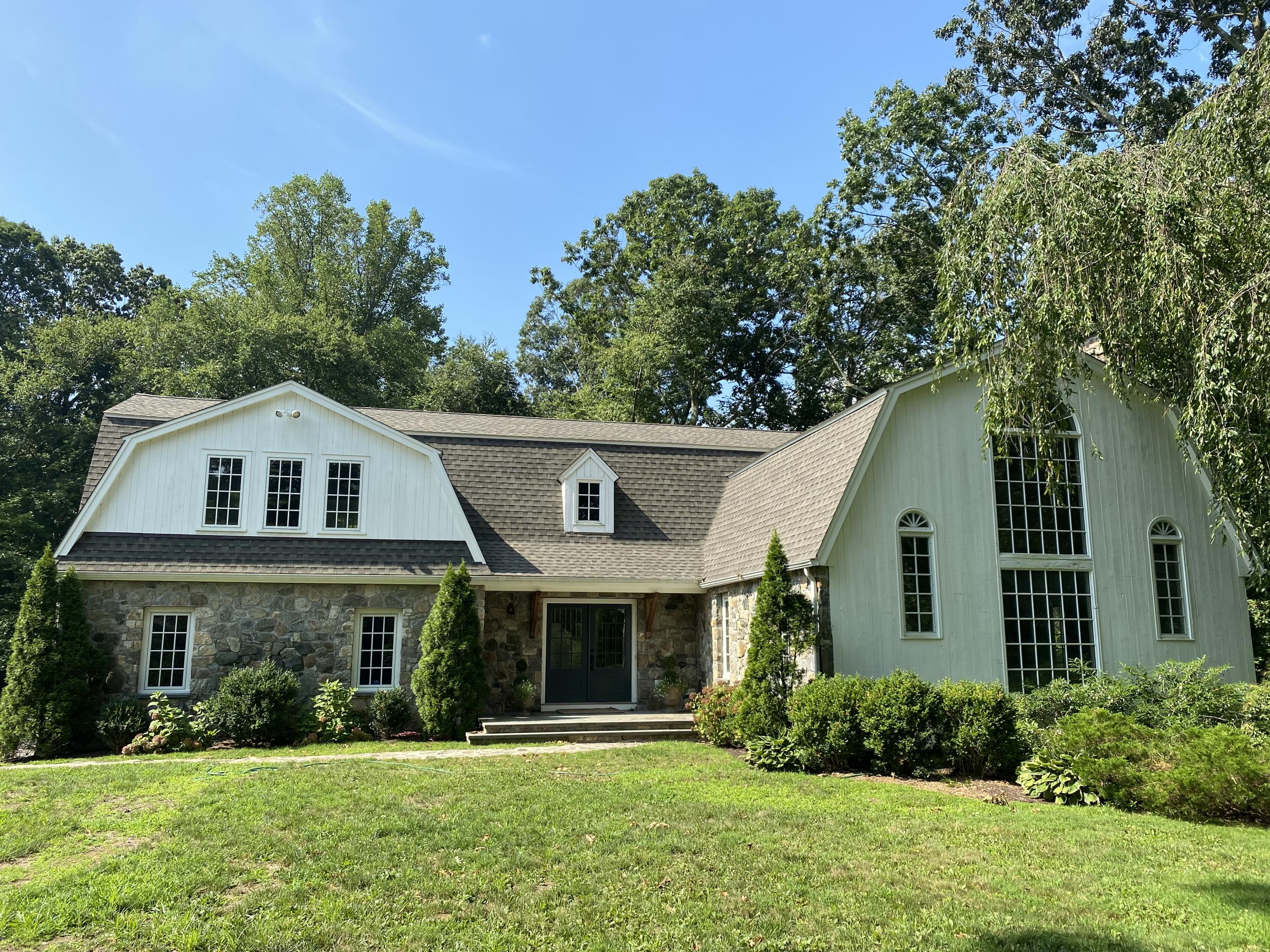 19 Clapboard Hill Road New Canaan, CT 06840 - Photo 1 of 30 a front view of a house with a yard