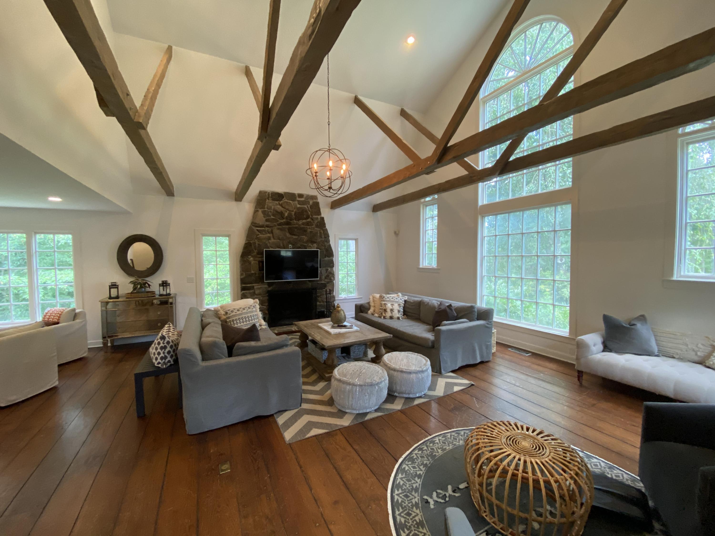19 Clapboard Hill Road New Canaan, CT 06840 - Photo 2 of 30 a living room with fireplace furniture and a large window