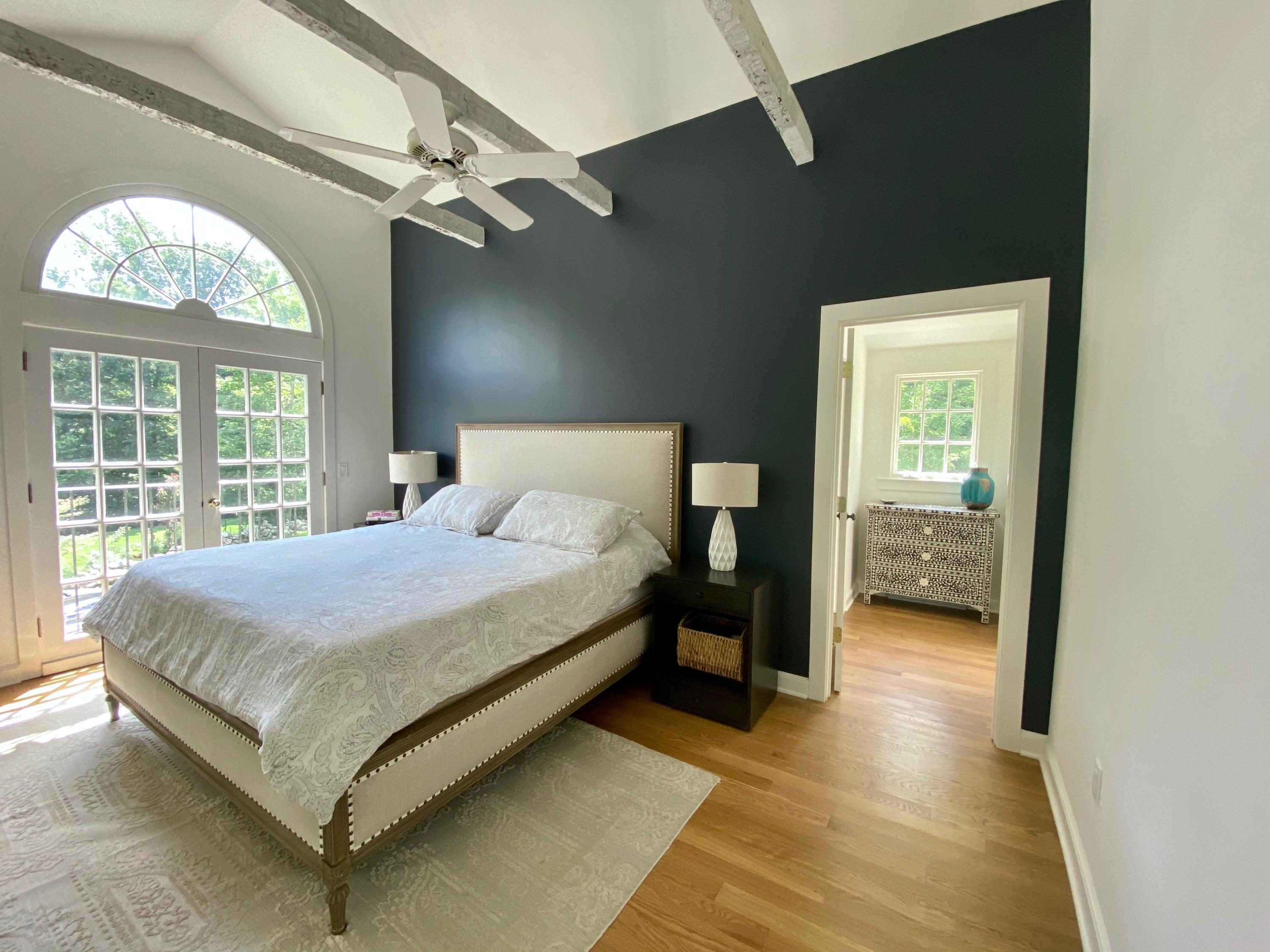 19 Clapboard Hill Road New Canaan, CT 06840 - Photo 13 of 30 a bedroom with a bed and a large window