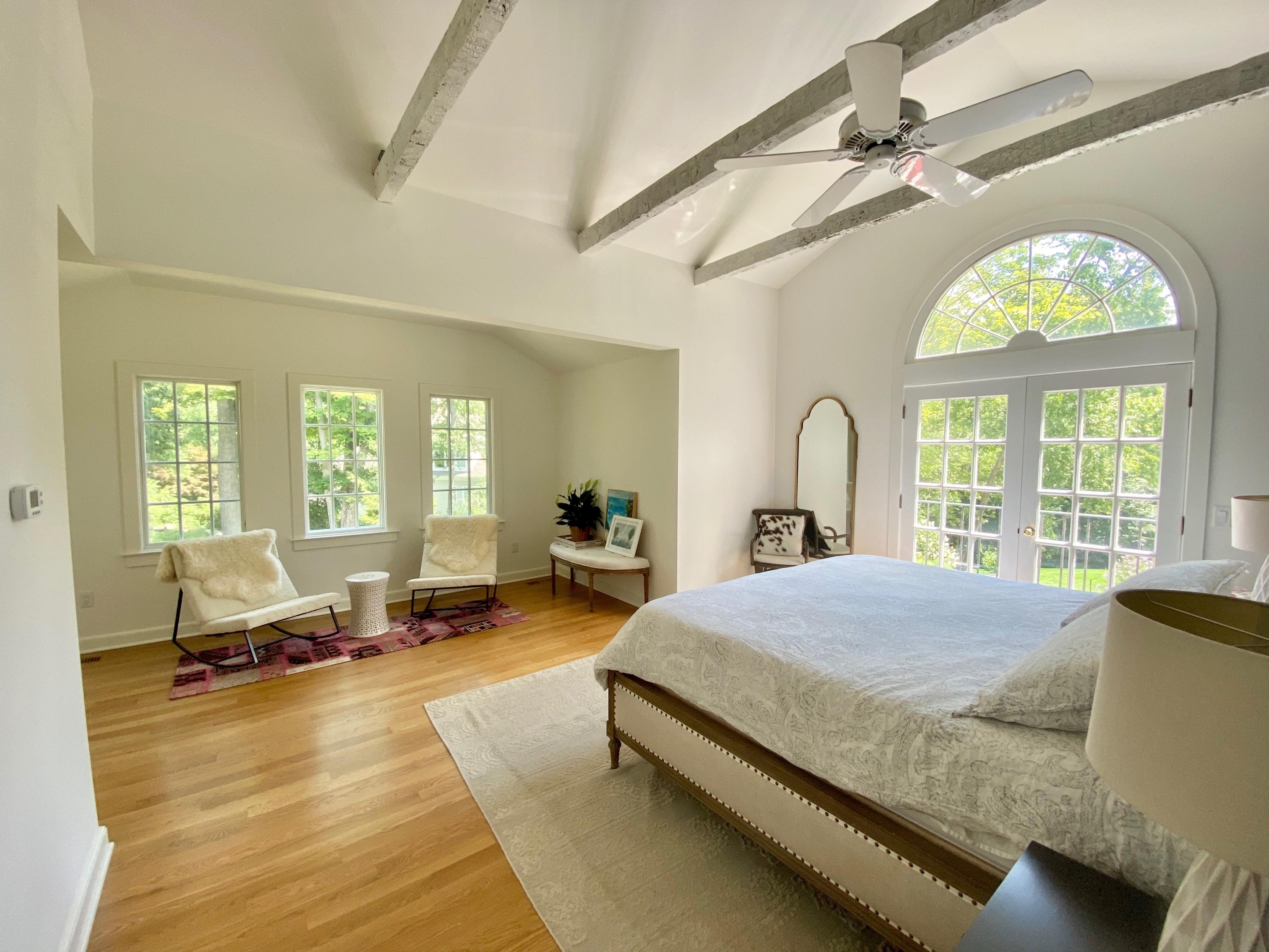 19 Clapboard Hill Road New Canaan, CT 06840 - Photo 14 of 30 a bedroom with a bed couch and a large window