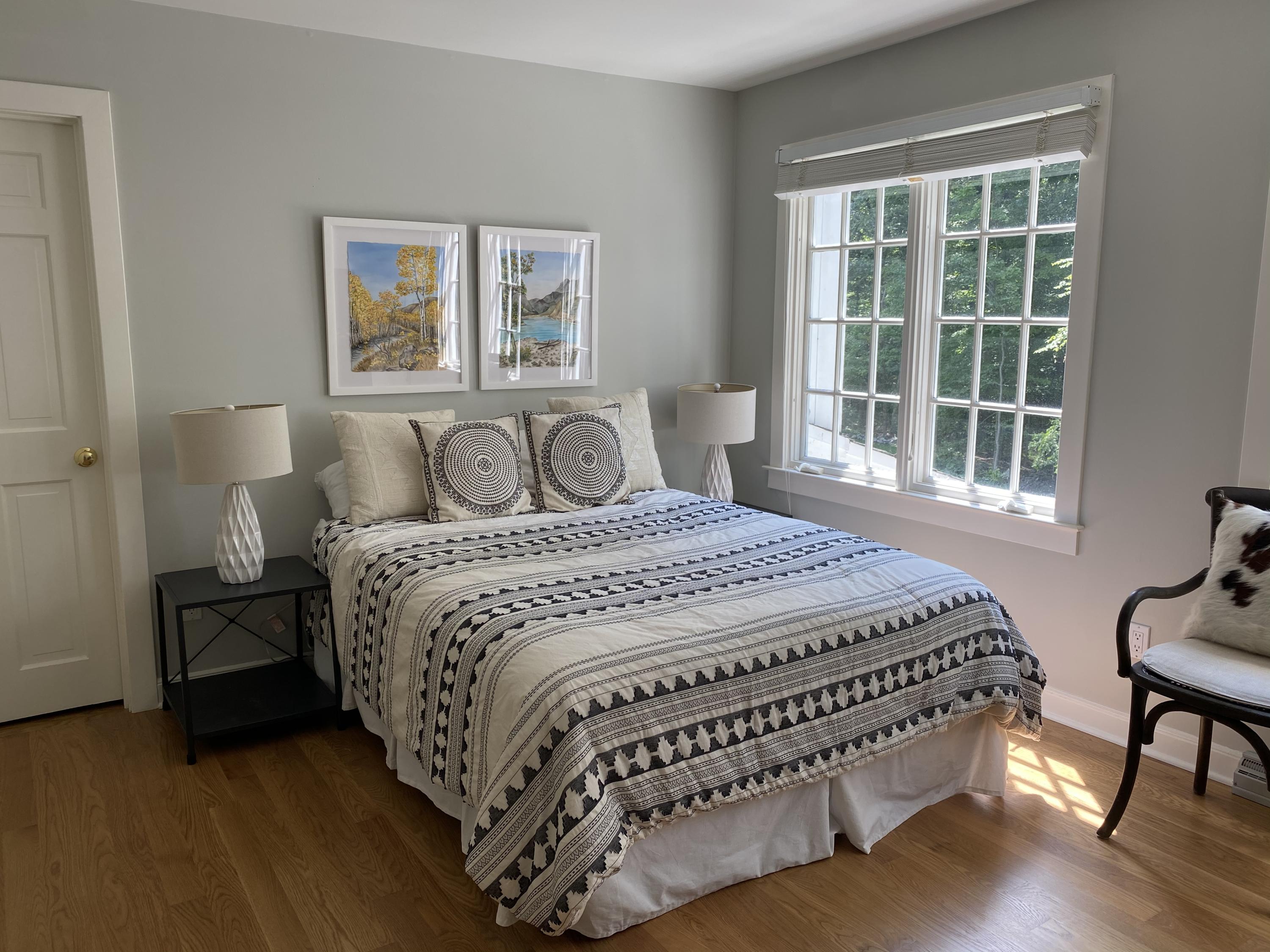 19 Clapboard Hill Road New Canaan, CT 06840 - Photo 18 of 30 a bedroom with a bed two lamps and a large window