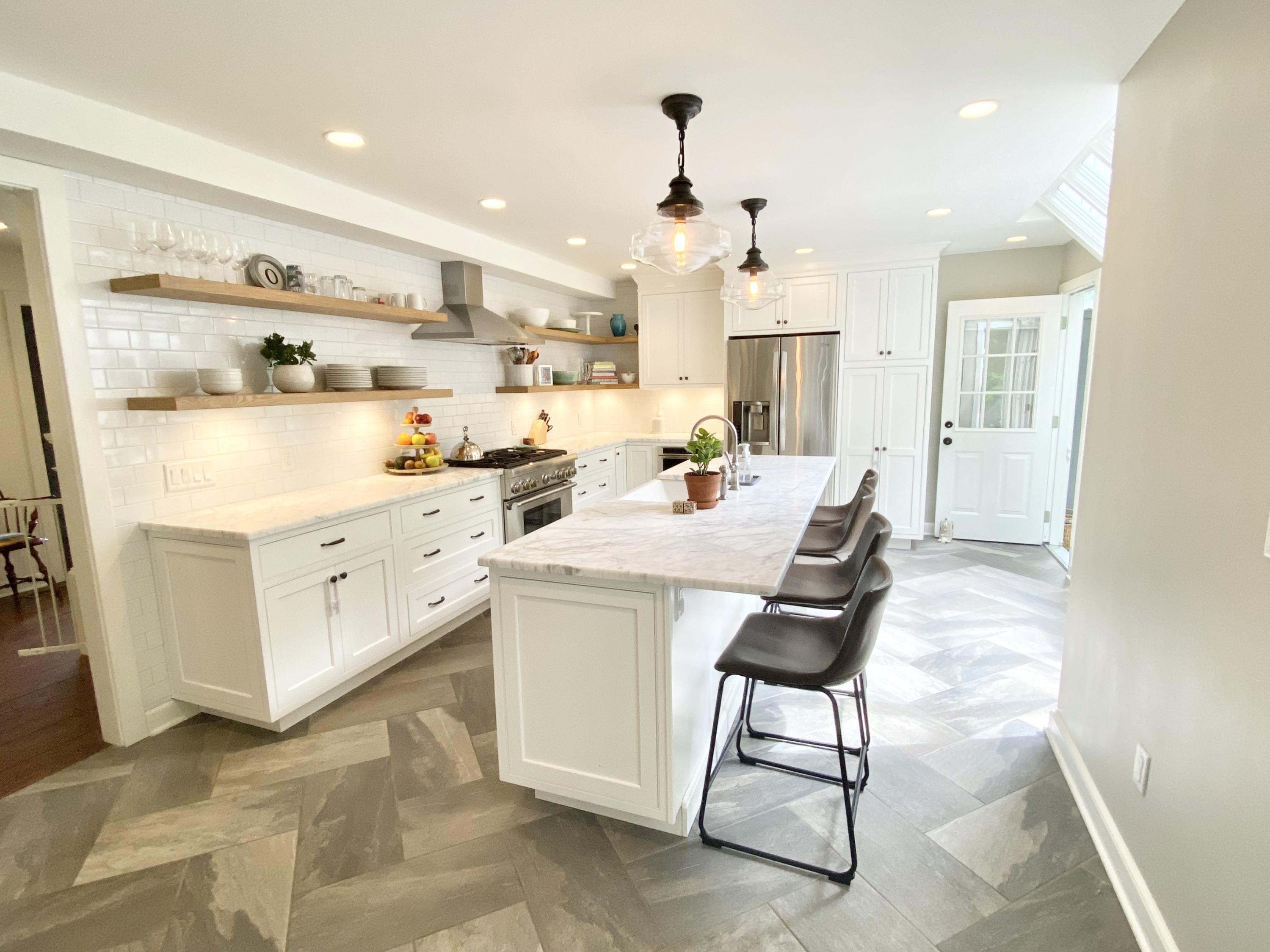 19 Clapboard Hill Road New Canaan, CT 06840 - Photo 7 of 30 a kitchen with a sink a stove a refrigerator and white cabinets with wooden floor