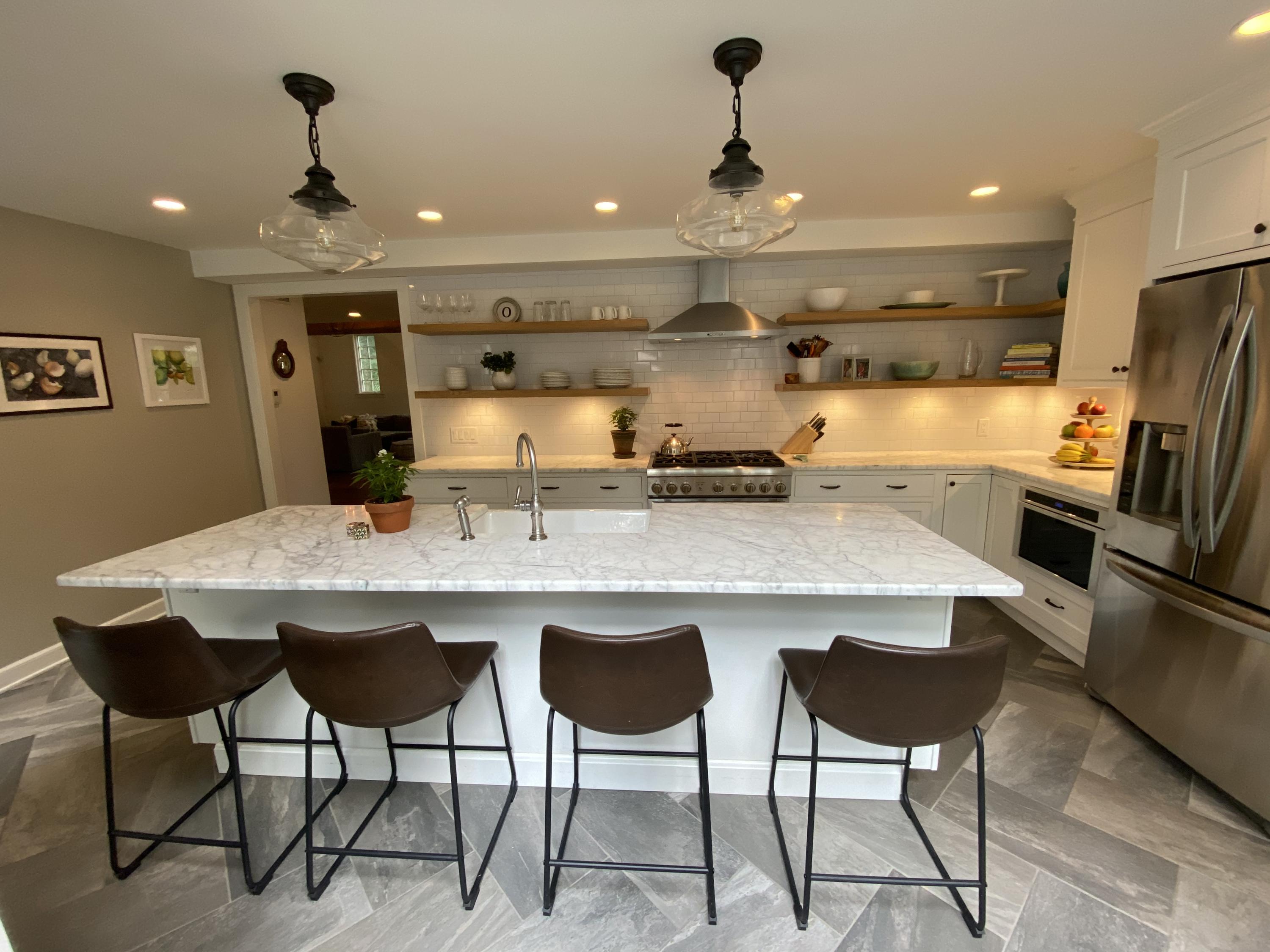 19 Clapboard Hill Road New Canaan, CT 06840 - Photo 9 of 30 a kitchen with stainless steel appliances granite countertop a dining table chairs refrigerator and sink