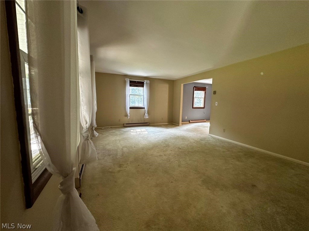 2093 Cambridge Road Coshocton, OH 43812 - Photo 8 of 32 Unfurnished room featuring carpet floors and baseboard heating