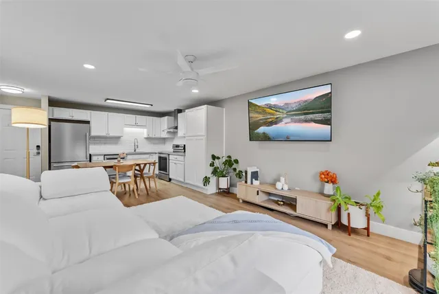a living room with furniture and a chandelier