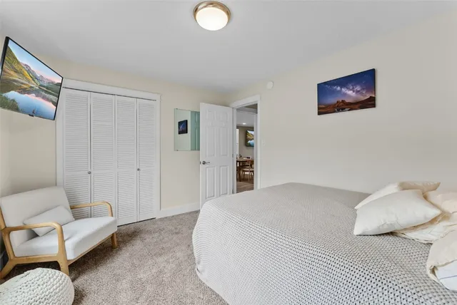 a spacious bedroom with a bed and a couch