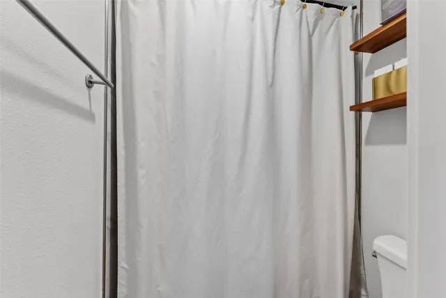 a view of a bathroom with a shower curtain