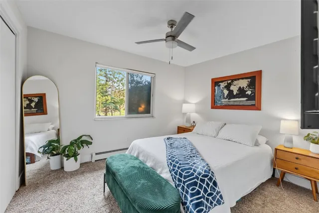 a bedroom with a bed and a potted plant