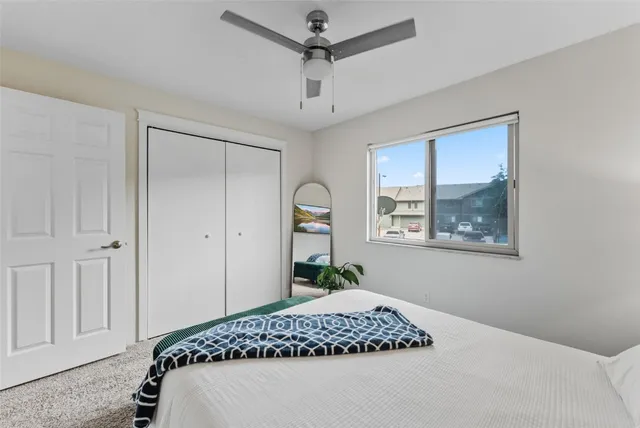 a bedroom with a bed and a window