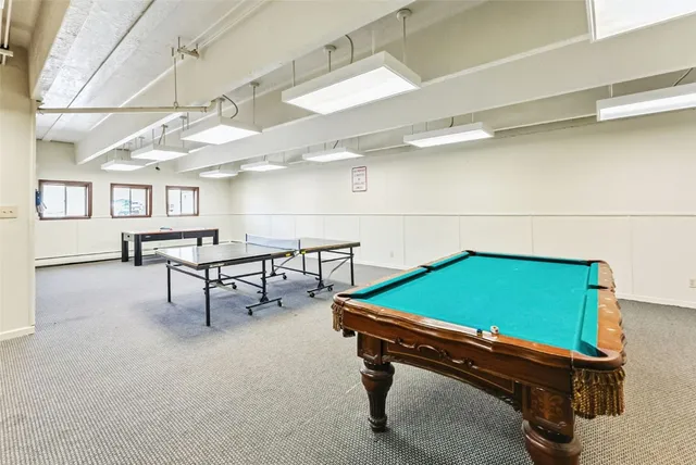 a room with pool tables and windows
