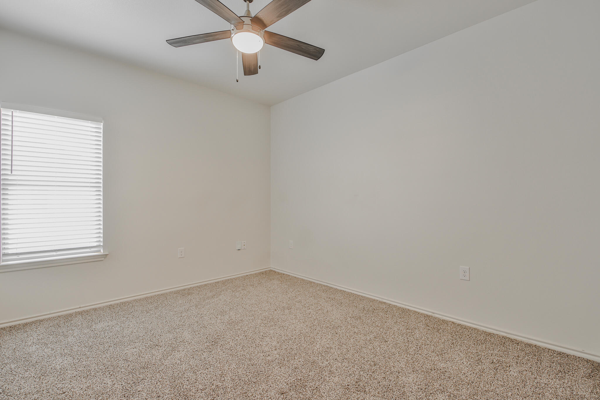 5512 Kemper Street Lubbock, TX 79416 - Photo 15 of 34 an empty room with a window and a fan