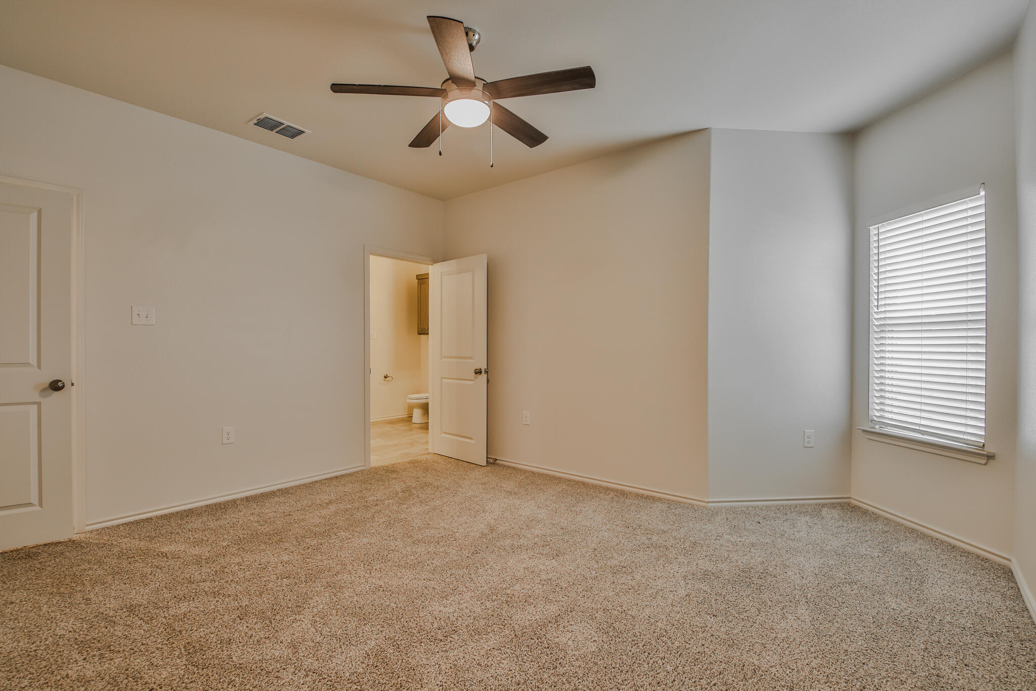 5512 Kemper Street Lubbock, TX 79416 - Photo 20 of 34 a view of an empty room with a window
