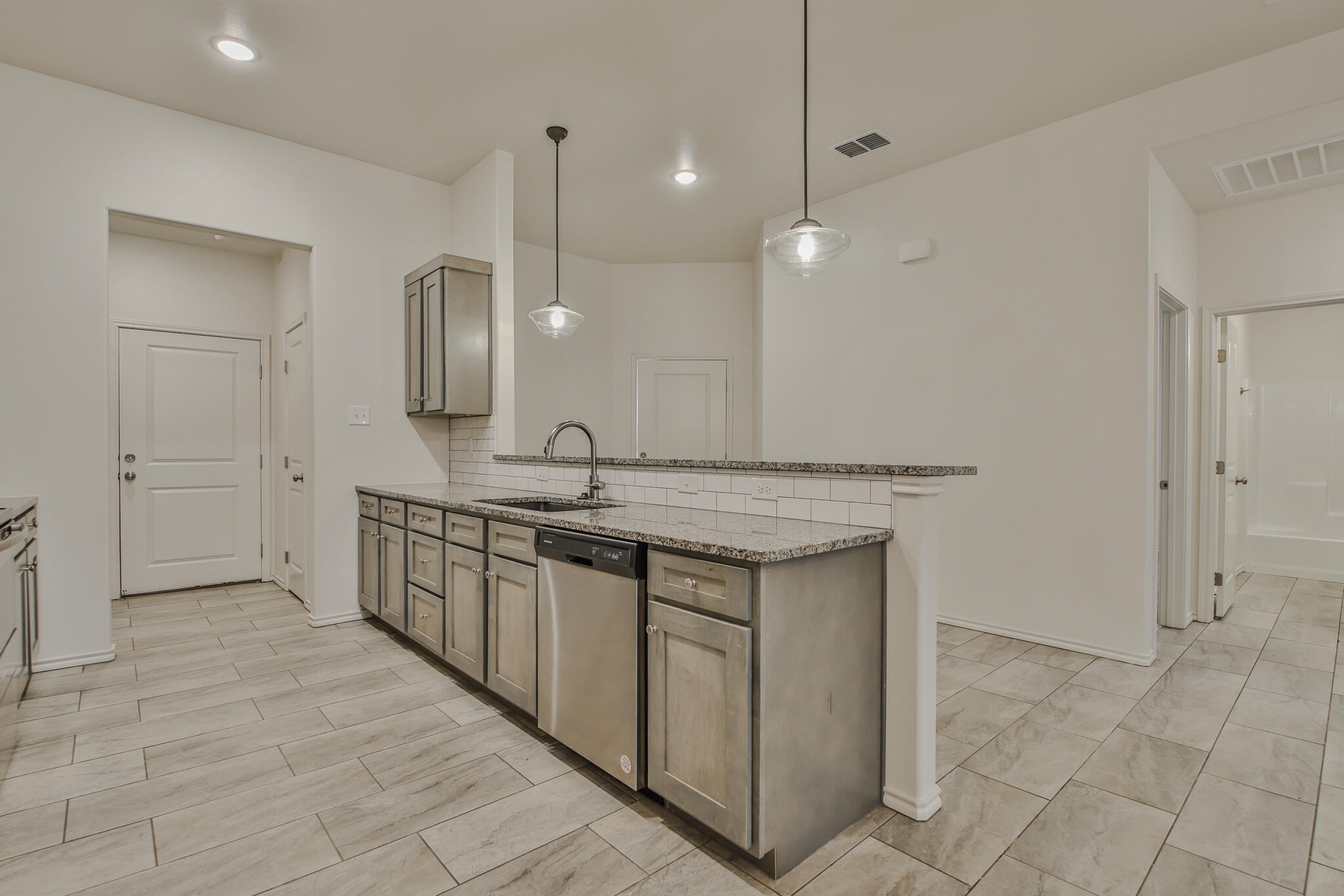 5512 Kemper Street Lubbock, TX 79416 - Photo 3 of 34 a bathroom with a double vanity sink a mirror and a shower