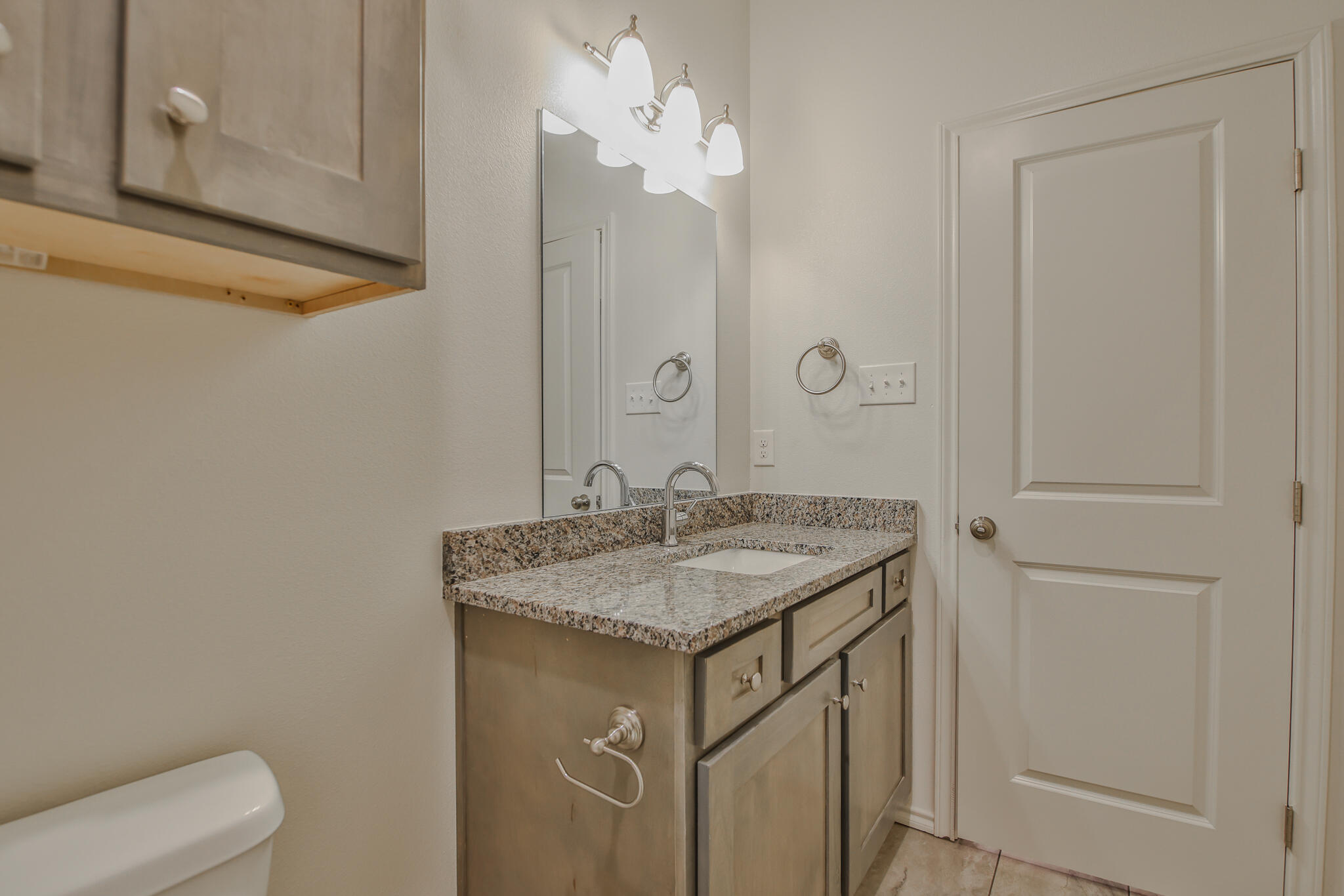 5512 Kemper Street Lubbock, TX 79416 - Photo 10 of 34 a bathroom with a granite countertop sink and a mirror