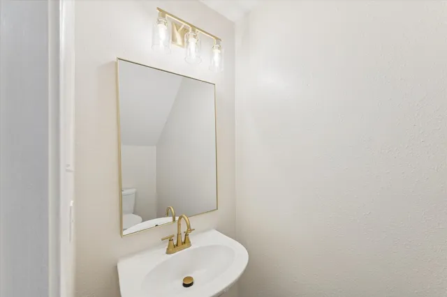 a bathroom with a sink and mirror